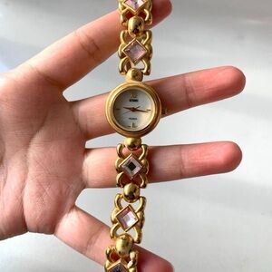 Gitano Gold tone watch with pink crystal crystal stones 7.75”